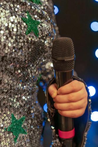 a person holding a microphone in their hand at The Grand Burstin Hotel in Folkestone