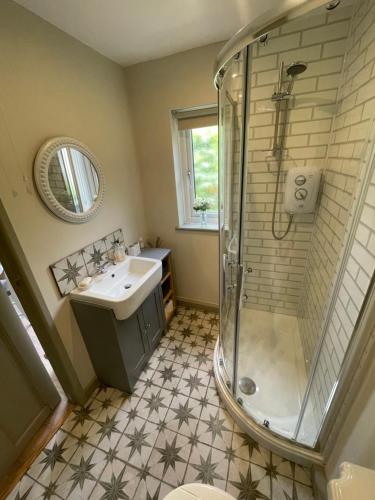 a bathroom with a shower and a sink at Lavender Lodge in Briston
