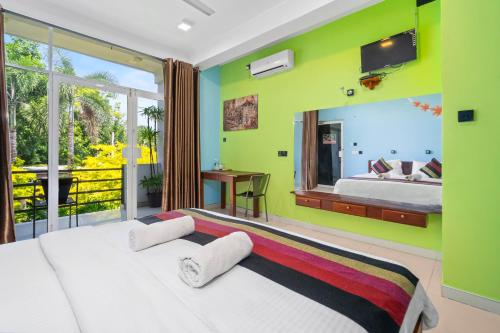 a bedroom with a white bed and a large window at The Panorama Negombo in Negombo