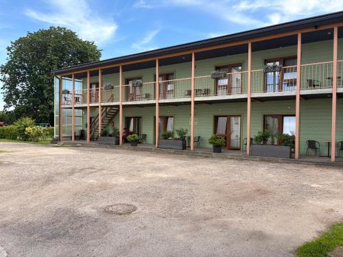 a large green building with plants on the balconies at Endla Hostel ja Apartamendid in Haapsalu