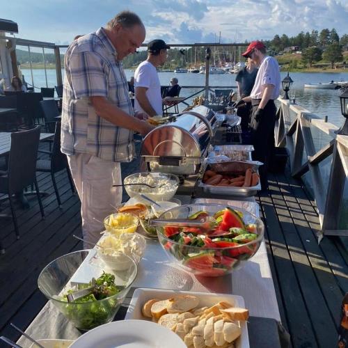 a buffet of food on a table on a boat at Norrfällsvikens Vandrarhem in Mjällom