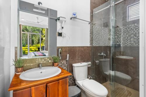 a bathroom with a toilet and a sink and a shower at The Panorama Negombo in Negombo