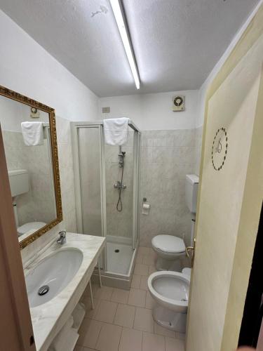 a bathroom with a sink and a toilet and a shower at Oberthaler Hotel in Sappada
