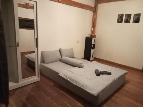 a room with a bed and a mirror in it at A2 Coconut in Pulau Sarang