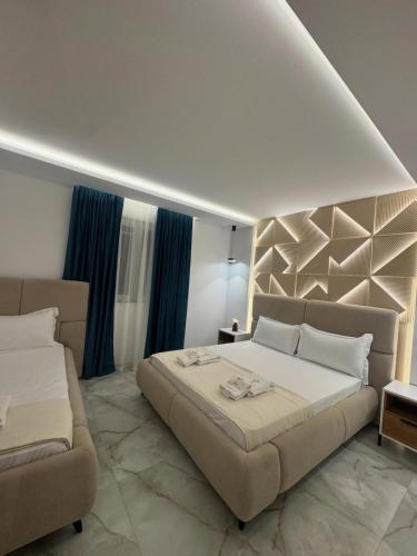 a bedroom with a large bed and a couch at Casa Palma Villa in Velipojë
