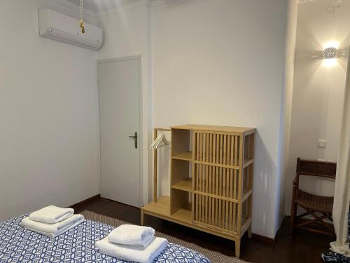 a room with two beds and a book shelf with towels at Casa Filita 'Old Town Traditional House' in Kos