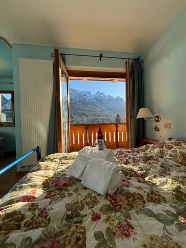 a bedroom with a bed with a santa hat on it at Oberthaler Hotel in Sappada