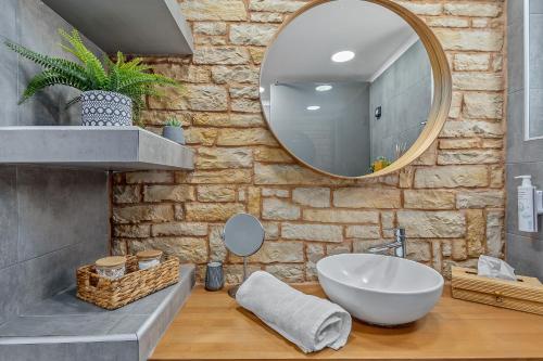 a bathroom with a white sink and a mirror at S-EVA RESORT in Kolymbia