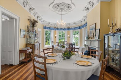 a dining room with a white table and chairs at Rockwood Manor Bed & Breakfast in Dublin