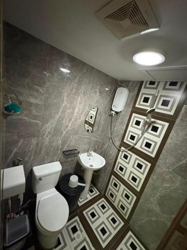 a bathroom with a toilet and a sink at At LBS 888 Condo Unit Rental-Full Relaxing Seaview 304-10Flr in Lapu Lapu City