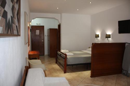 a small bedroom with a bed and a mirror at Mahi Studios in Patitiri