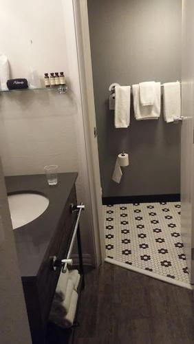 a bathroom with a sink and a toilet and towels at enVision Hotel Worcester Downtown in Worcester