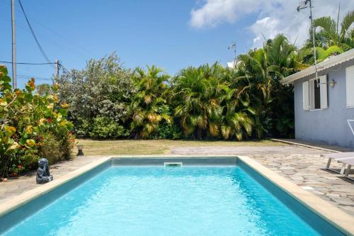 a swimming pool in the backyard of a house at Villa Aquarium in Saint-François