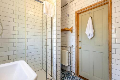 a bathroom with a shower and a sink and a door at 4 Bed in Reydon oc-l30001 in Reydon