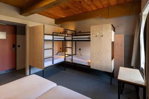 a room with three bunk beds in it at Stayokay Hostel Heemskerk - fully renovated April 2026 in Heemskerk
