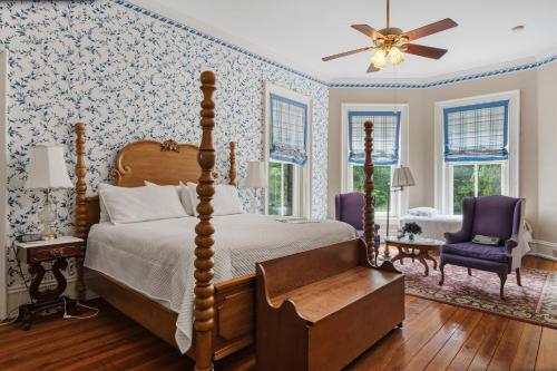 a bedroom with a canopy bed and blue and white wallpaper at Rockwood Manor Bed & Breakfast in Dublin