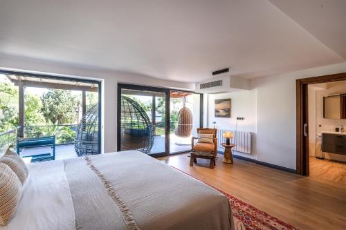 a bedroom with a bed and a balcony at Sea View Villa in most upscale Yalikavak in Bodrum City