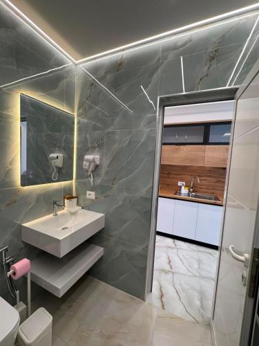 a bathroom with a sink and a mirror at Casa Palma Villa in Velipojë