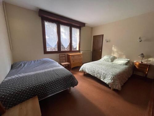 a bedroom with two beds and a window at Maison bord de mer proche des Sables d'Olonne in Talmont