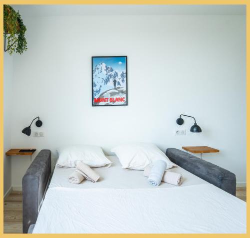 a bedroom with a large bed with white sheets and pillows at Chez Gilles I Studio I Ambilly in Ambilly