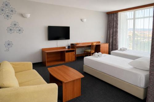 a hotel room with two beds and a television at MPM Hotel Kalina Garden - All Inclusive in Sunny Beach