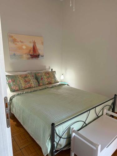 a small bedroom with a bed and a chair at George's place in Plytra