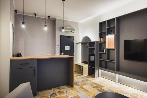 eine Küche mit Arbeitsfläche und Fernseher in einem Zimmer in der Unterkunft Hotel Soho - Renovated 2026 in Tartu