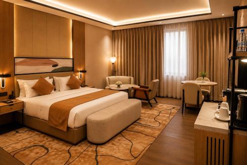 a hotel room with a bed and a table and chairs at Twin Burj Hotel in Nouakchott