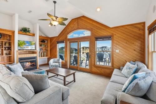 a living room with two couches and a fireplace at 6118 - Ferrari II in Nags Head