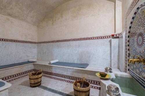 a bathroom with a tub and a sink at Hotel Xaluca Dades in Boumalne Dades