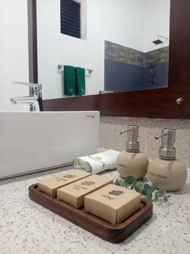 a bathroom with two bottles of soap on a counter at Lavish Resort Sigiriya in Inamaluwa