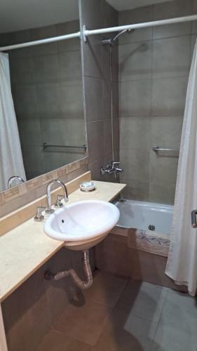 a bathroom with a sink and a bath tub at Bahia creek in Las Grutas