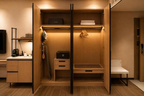 a room with a closet with a desk and a bed at Twin Burj Hotel in Nouakchott