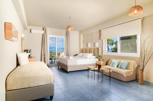 a bedroom with a bed and a couch in a room at Kohylia by La Scala Beach in Limenas