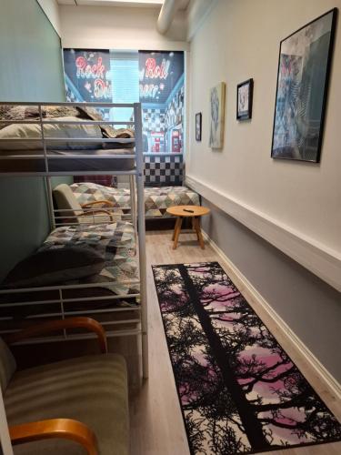 a room with bunk beds and a rug at Schools Out OY in Loviisa