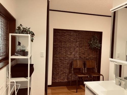 a living room with a brick wall and a doorway at HOUSE26 Private Villa near Green Expo Yokohama in Machida