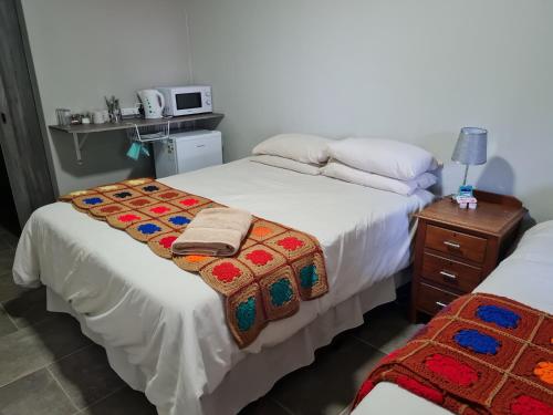 a bedroom with two beds with towels on them at House 205 in Vanderbijlpark