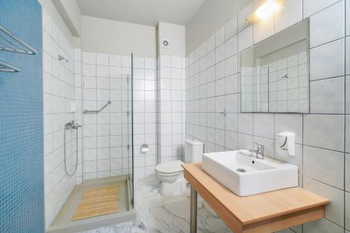 a bathroom with a sink and a shower and a toilet at Kohylia by La Scala Beach in Limenas