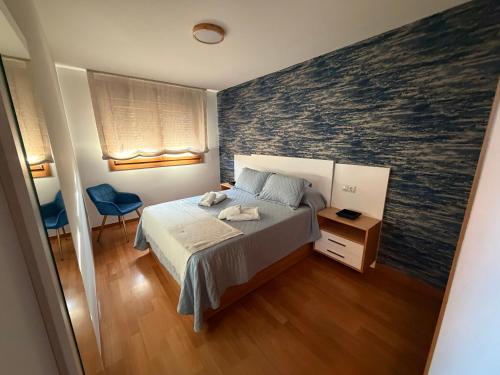 a bedroom with a bed and a large wall mural at Vista Santa Mariña in Cambados