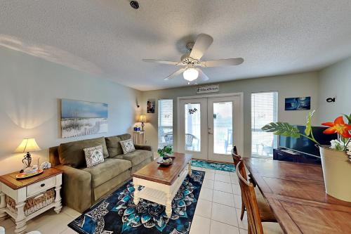 a living room with a couch and a table at Grand Caribbean Perdido Key #306 West in Perdido Key