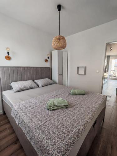 a bedroom with a large bed with a green pillow on it at Villa apartment Laganini in Okrug Gornji