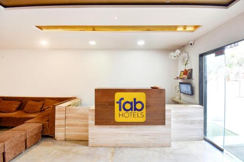 a living room with a big yellow sign on the wall at FabHotel Tiru Rooms in Pune