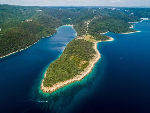 an island in the middle of a body of water at Istria Sea Side Apartments Lina in Labin