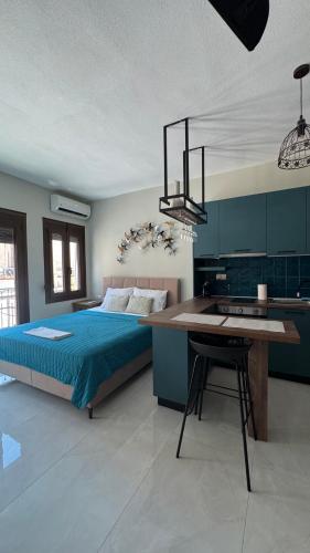 a bedroom with a bed and a desk in it at J&B Suites in Kavála