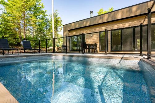 a swimming pool in front of a house at Private Pool & Spa - Chalet Bella Vista in Saint Come