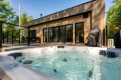 a hot tub in front of a house at Private Pool & Spa - Chalet Bella Vista in Saint Come