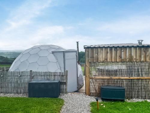 a soccer ball is sitting next to a fence at Pinhaw Beacon - Ukc9595 in Earby