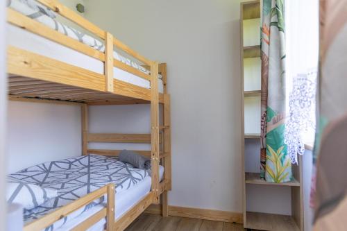 a bunk bed in a room with two bunk beds at Leśna Oaza in Sasino