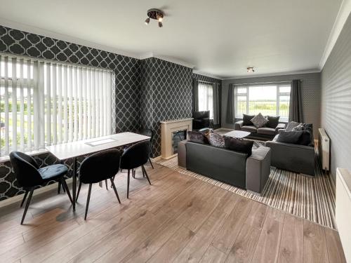 a living room with a couch and a table at Poplar Zareba in Anderby