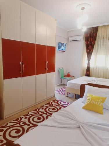 a bedroom with two beds and a cabinet at Arthouse Elbasan in Elbasan
